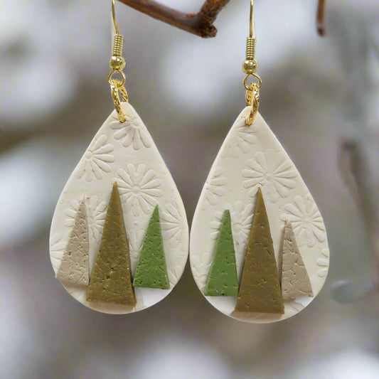 winter earrings with little trees on a white background 