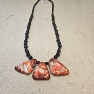 Orange and black necklace with polymer clay focal bead