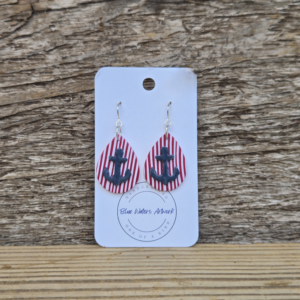 Handmade polymer clay teardrop earrings with red and white stripes and a blue anchor, nickel‑free ear wires.