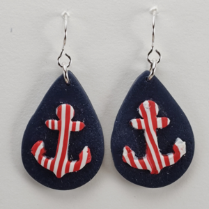 Handmade polymer clay teardrop earrings with red and white stripe anchor on a navy blue background, nickel‑free ear wires.